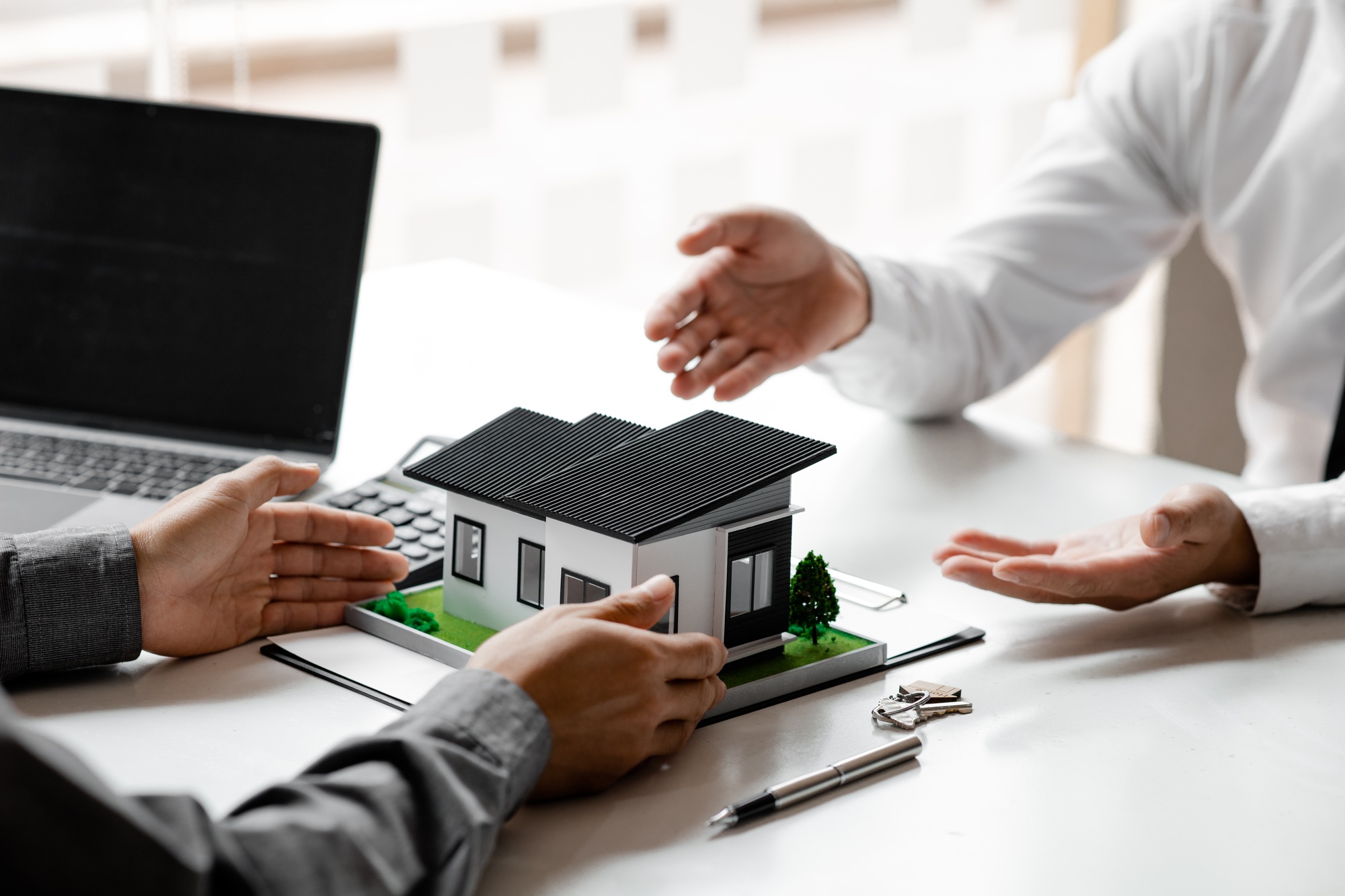 Real estate agents explain models of housing estates in projects.