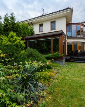Exterior of house surrounded by lush greenery